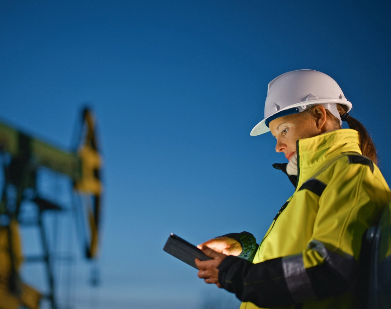 Stock image of Wireless Networks Mining worker on a mobile phone in high vis