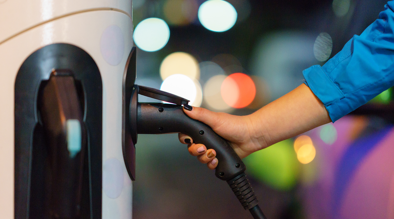 EV charger being plugged into car 