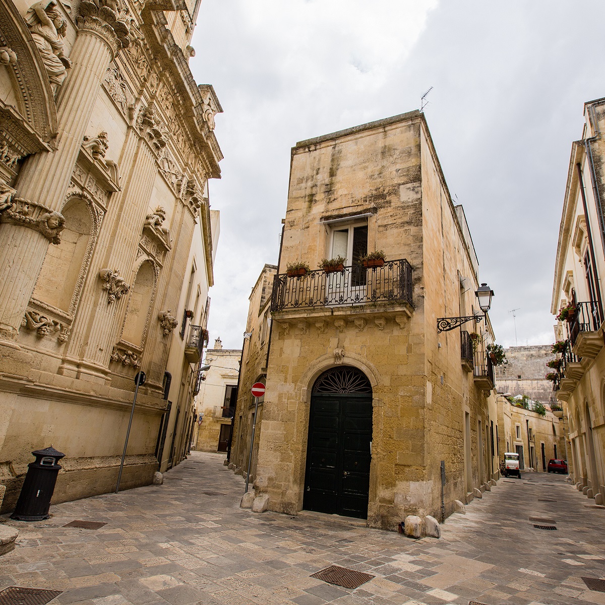 An empty stone street and historic stone buildings in Lecce, Italy