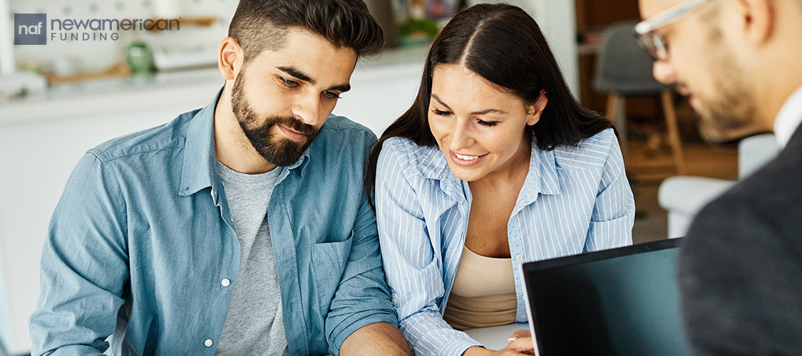 couple filling out paperwork with agent