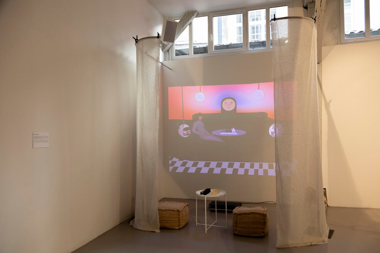 Projection artwork with surreal characters and chess set installation