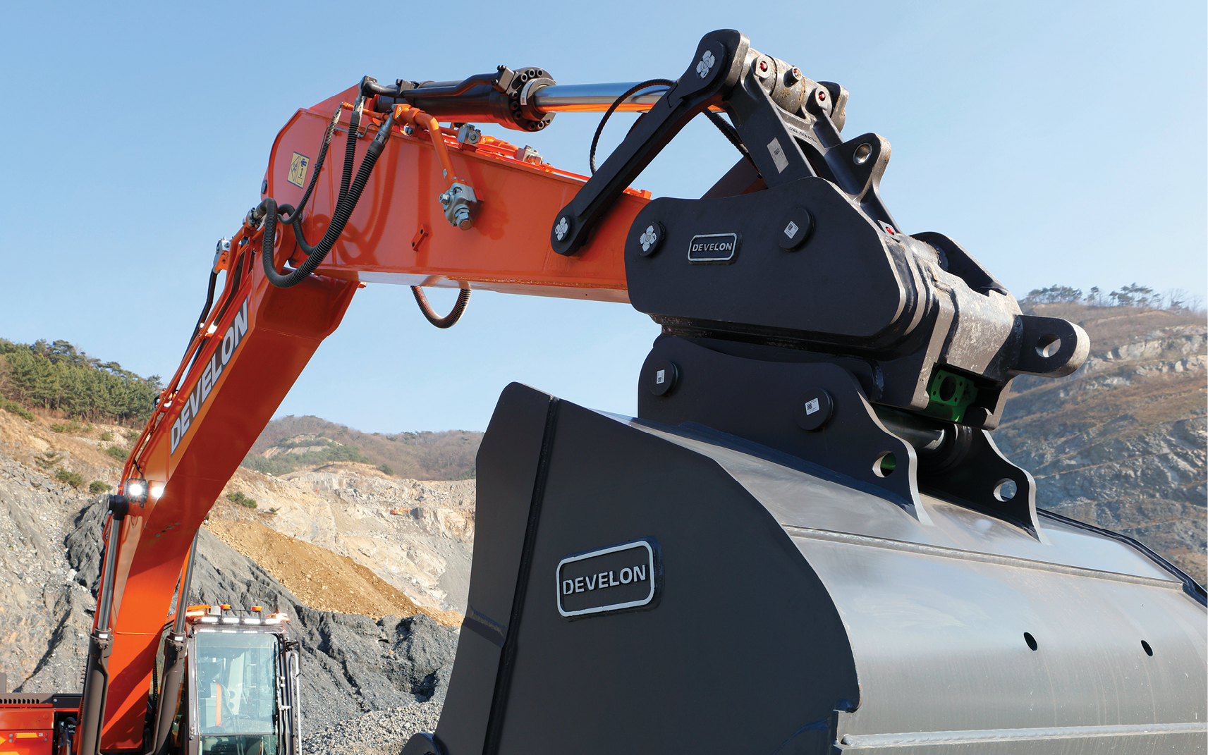 The arm and bucket on a DEVELON crawler excavator. 