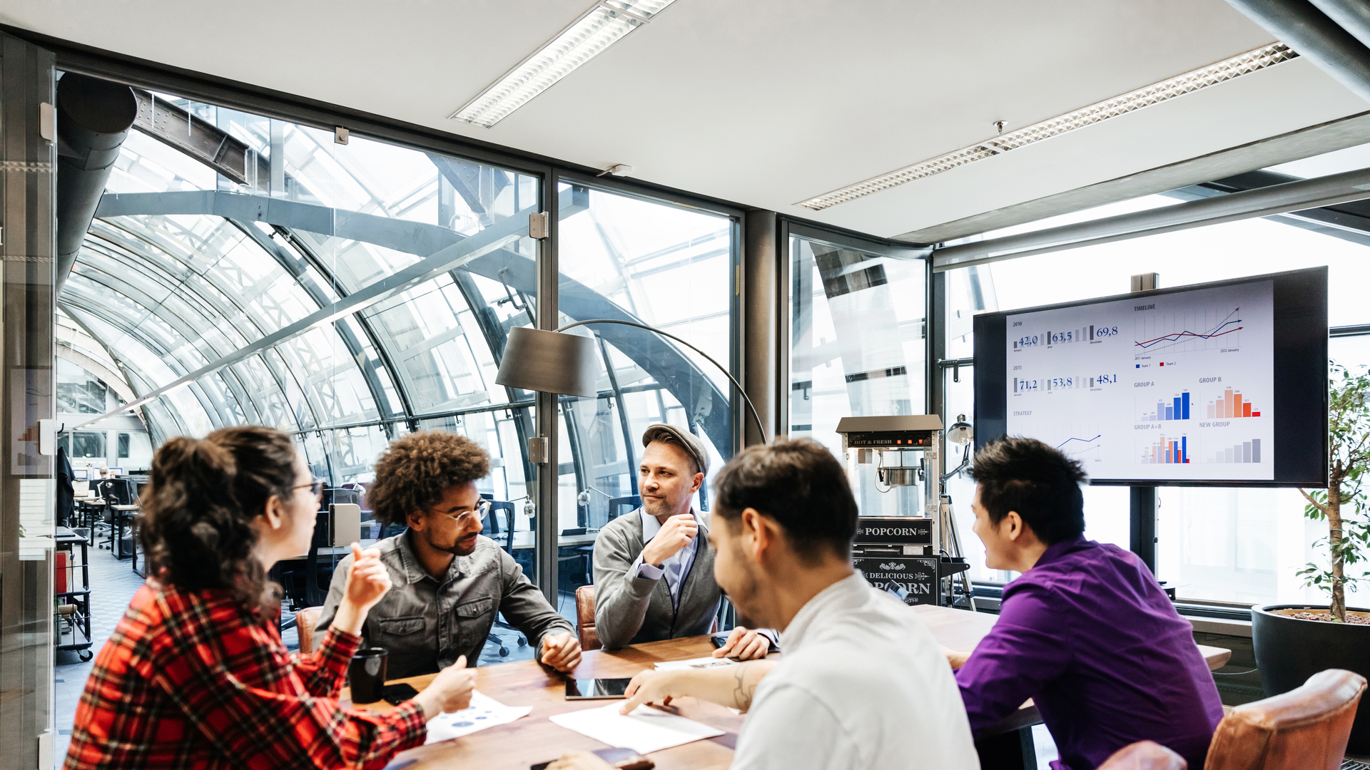 Team Leaders Sitting At Conference Table For Meeting