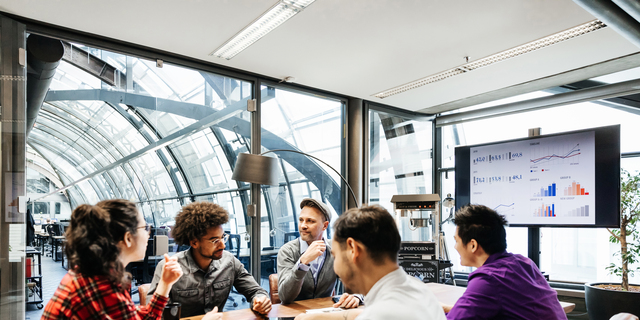 Team Leaders Sitting At Conference Table For Meeting