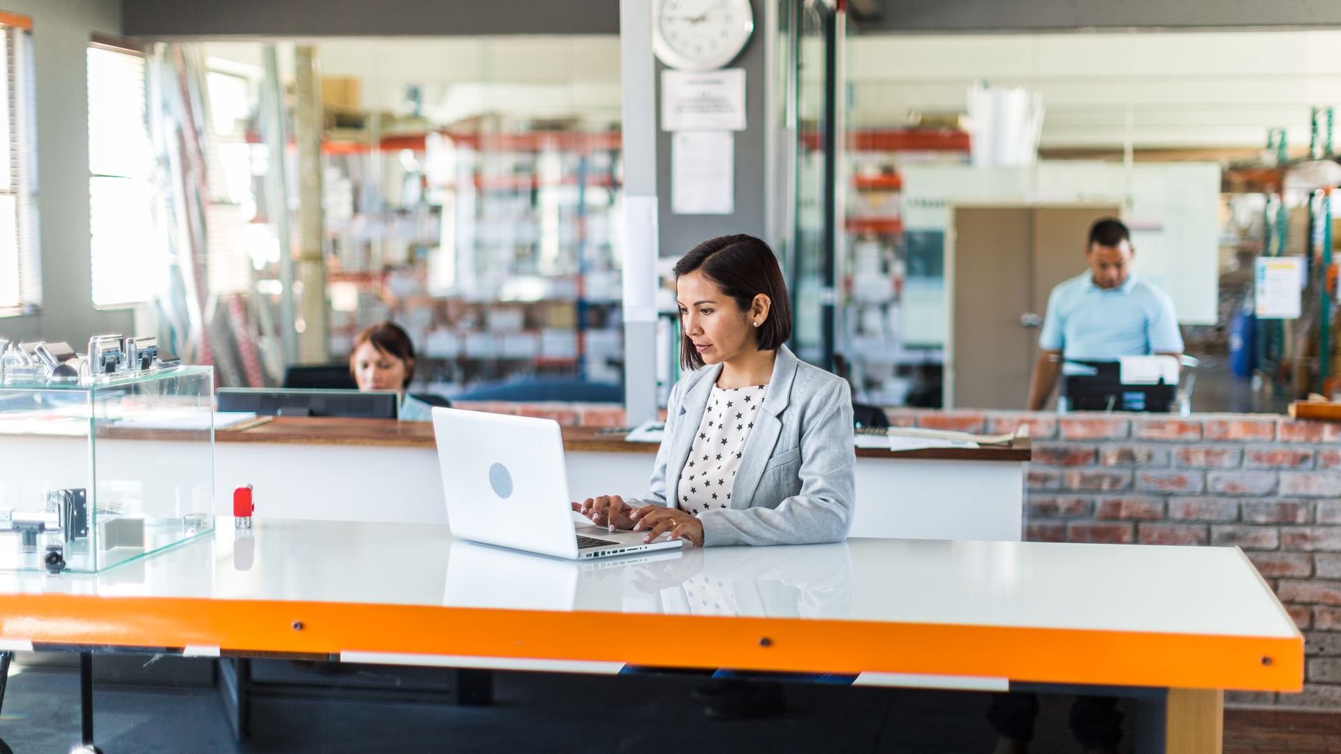 Female business woman in open plan office of a small business