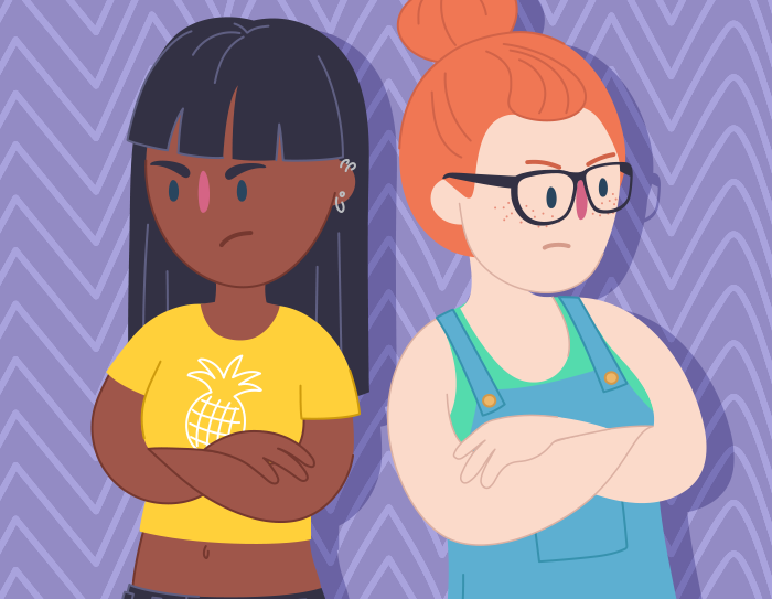 Two teen girls back-to-back with arms crossed