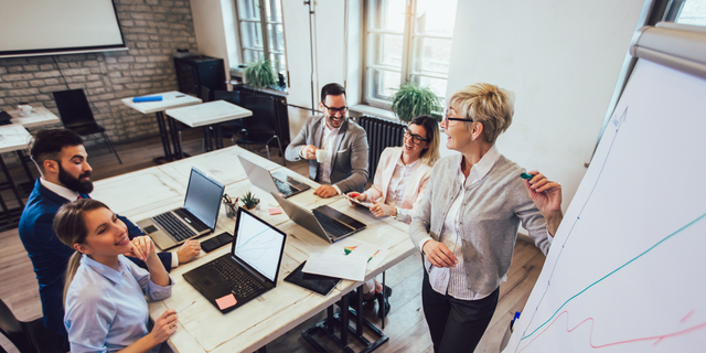 Business colleagues in conference meeting room during presentation