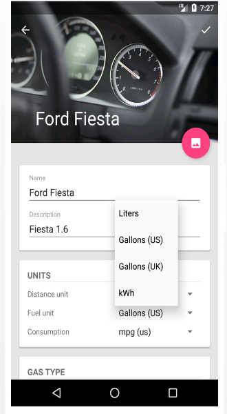 A mobile app screen showing the setup for a vehicle named "Ford Fiesta." The interface displays fields for name, description, and units of measurement including fuel unit options such as Liters, Gallons (US/UK), and kWh. A photo of a car dashboard with speedometers is visible at the top.