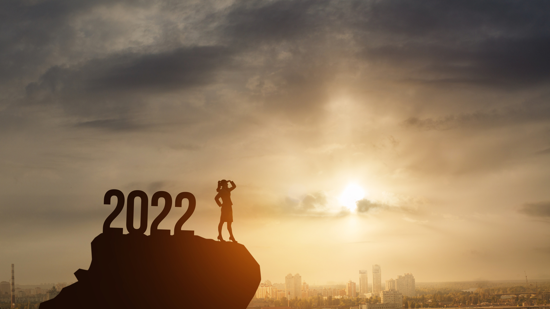 Businesswoman Standing on the mountain with 2022 New Year numbers.