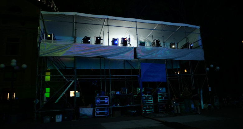 A series of 4K projectors are set up for the LUMA arts festival at night.