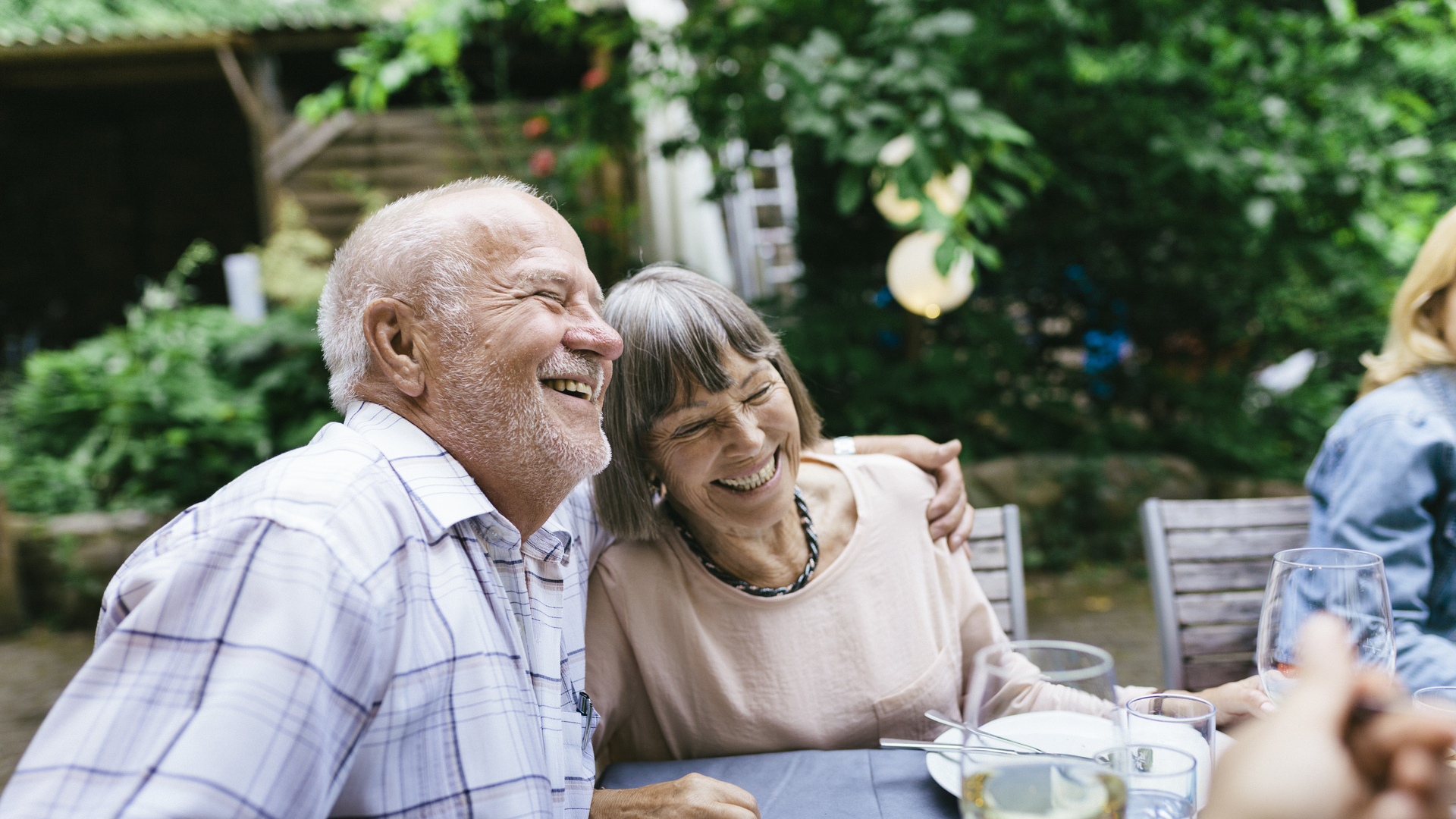 Elderly Couple Enjoying Outdoor Meal With Family