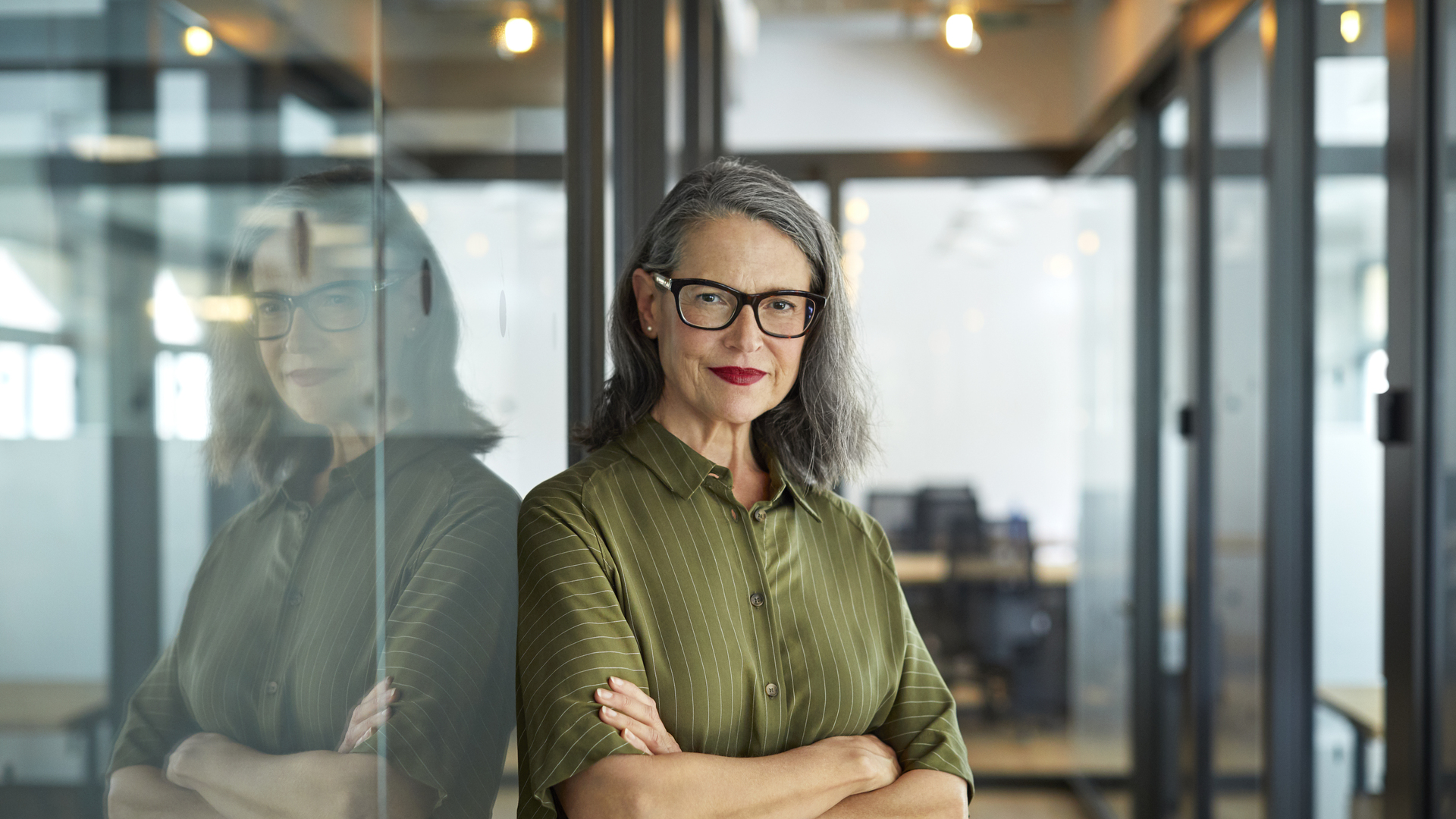 Confident mature businesswoman with arms crossed