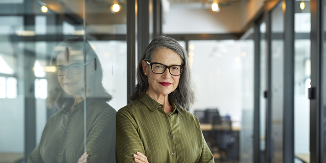 Confident mature businesswoman with arms crossed