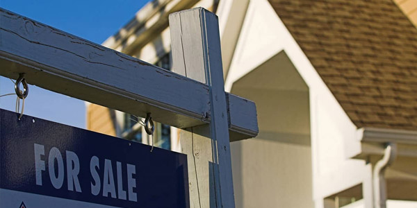 house with a for sale sign out front 
