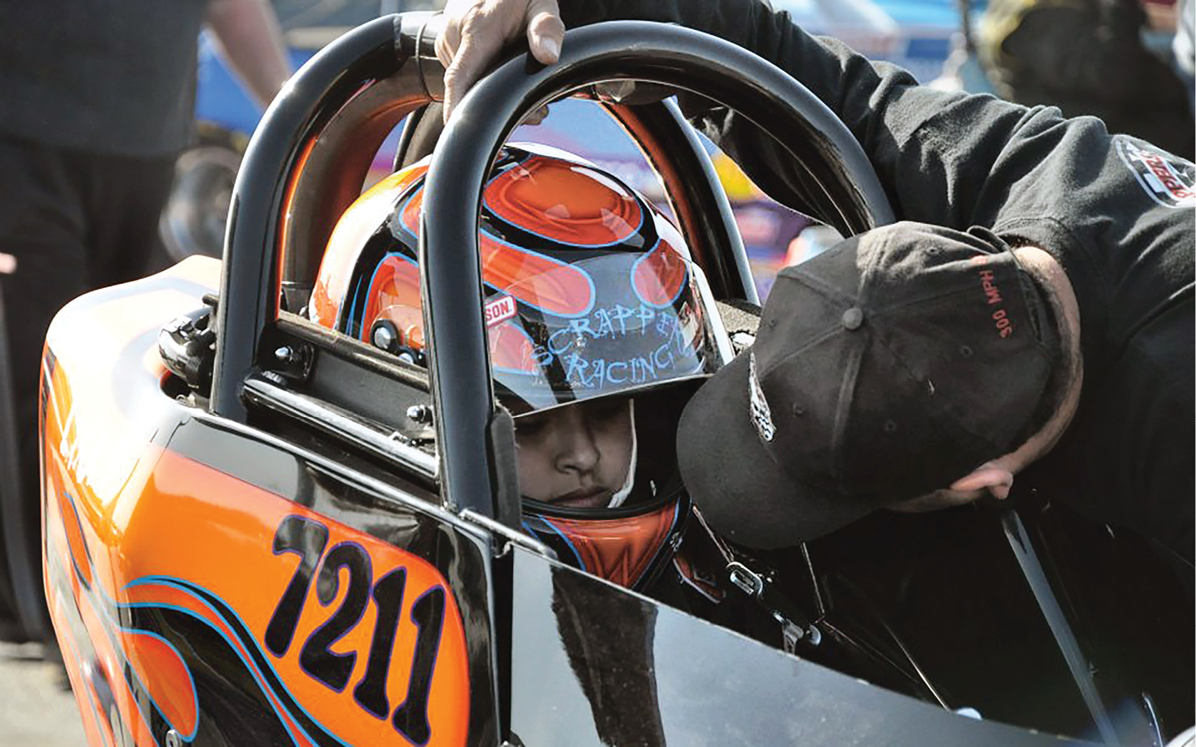 A Scrappers Racing driver has a conversation with a crew member.