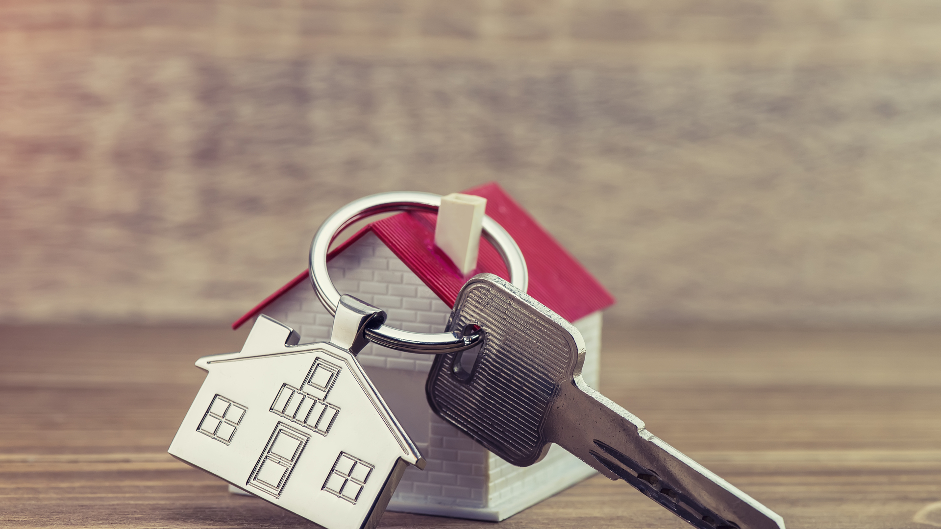 House Key And Key chain On Wooden Table