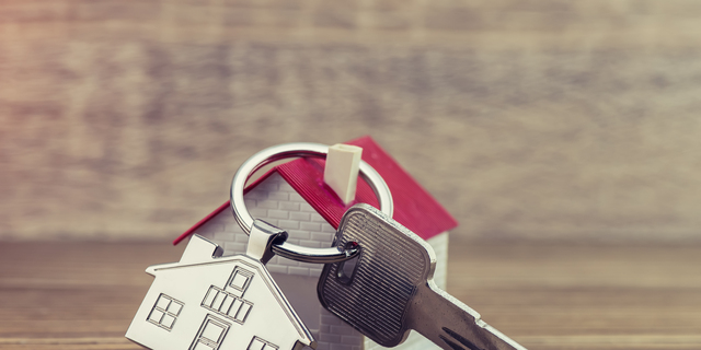 House Key And Key chain On Wooden Table