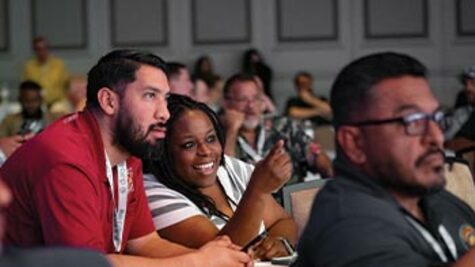 Telecommunications professionals engaged and listening during a presentation at a BICSI conference session