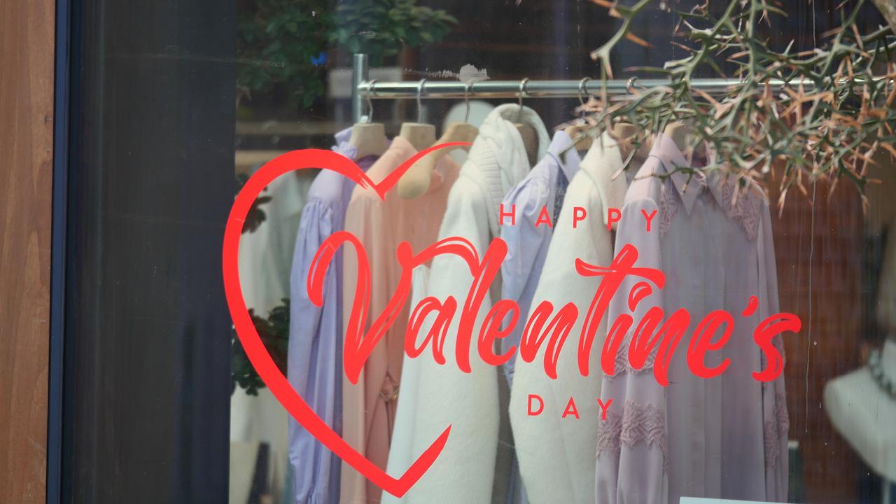 A store window with clothes on swingersAI-generated content may be incorrect.