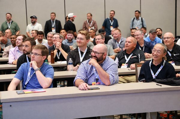 Telecommunications professionals attending a BICSI training session in a conference room.