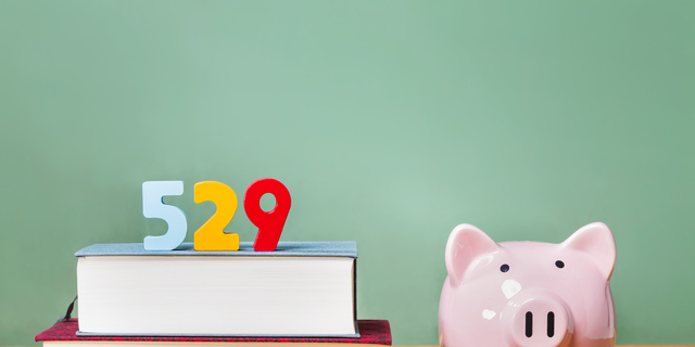 529 college savings plan theme with textbooks and piggy bank