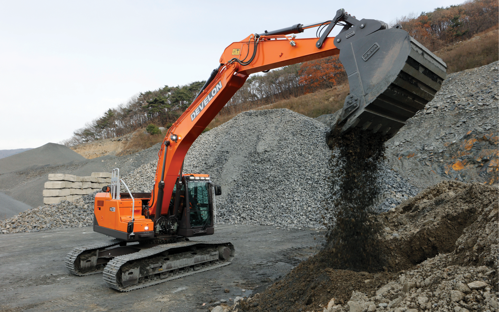 The new DEVELON -9 Series crawler excavator digging dirt on a job site.