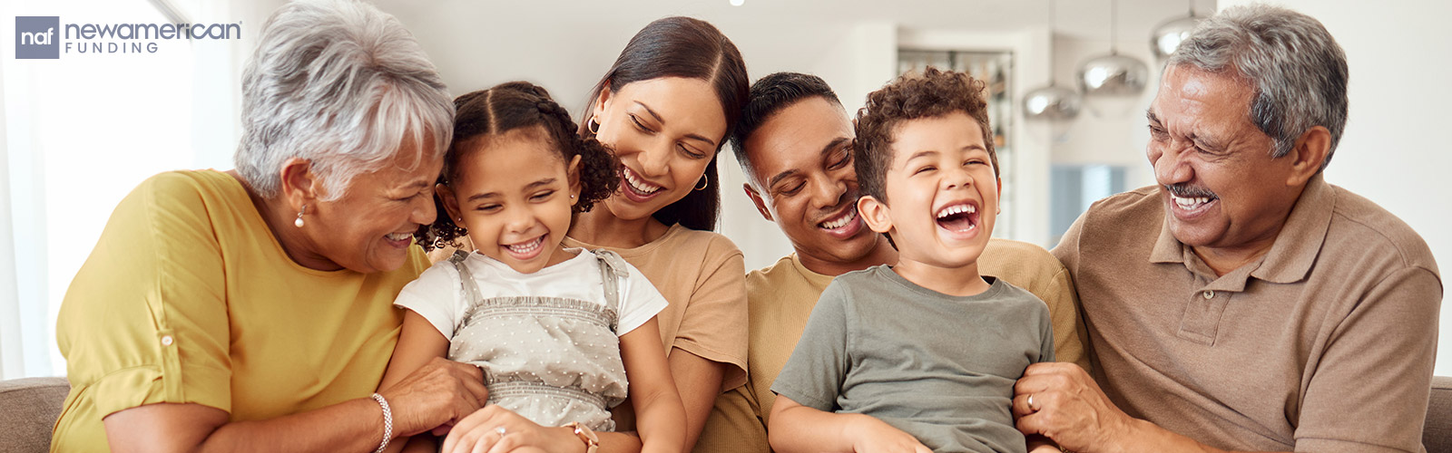 multi-generational family sitting on the living room couch together