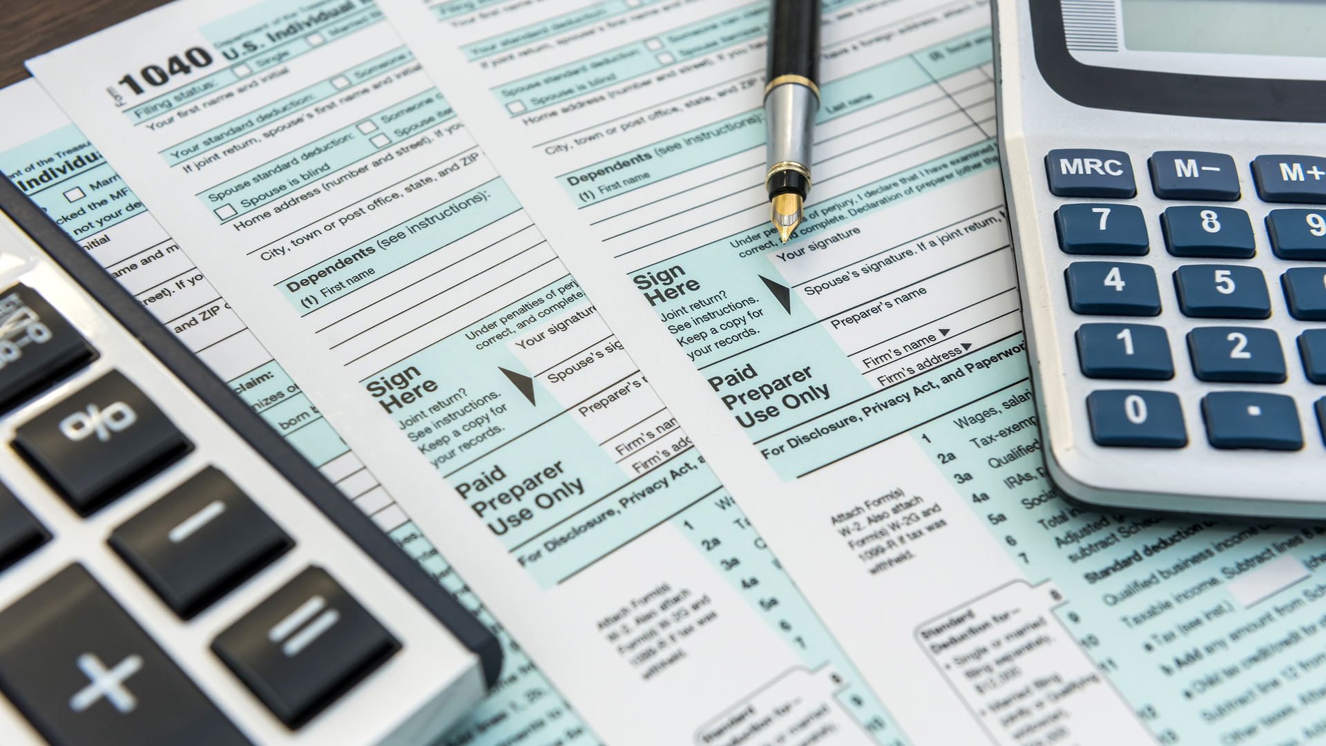 Tax Forms with Calculator and Pen. Financial accounting