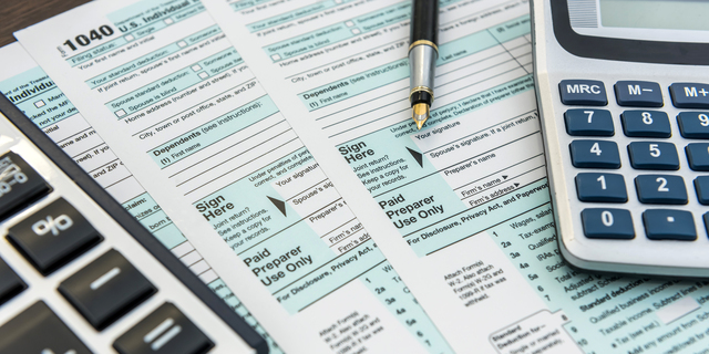 Tax Forms with Calculator and Pen. Financial accounting