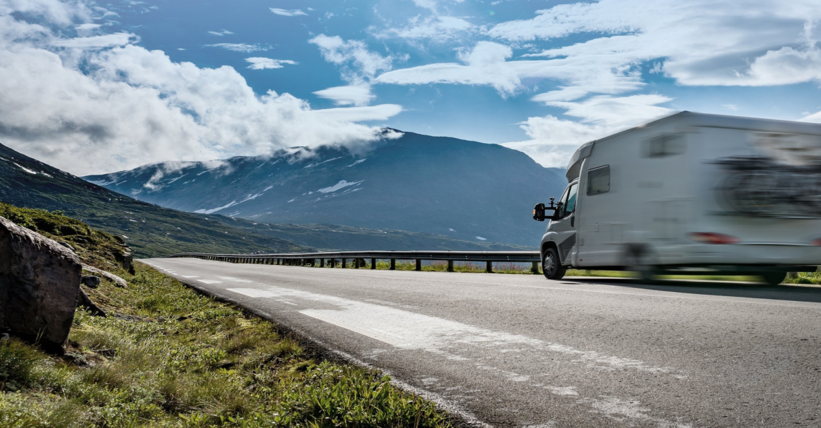 A campervan driving along a mountain road