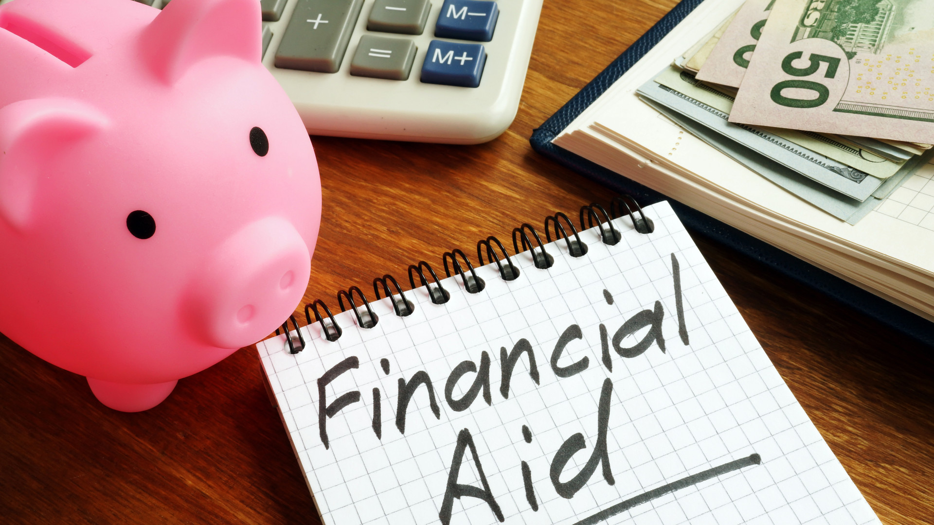 Financial aid sign with money and piggy bank.