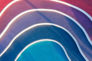 Colorful pools of water in a gradient of pink to blue - representing customer loyalty