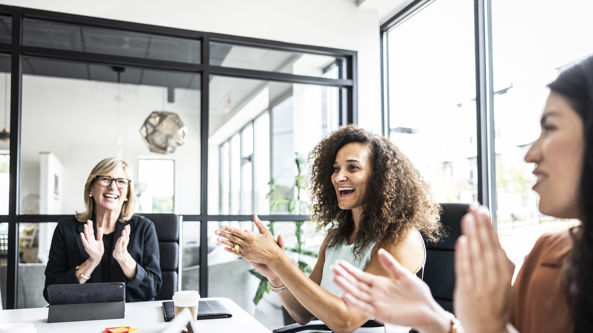 Business colleagues applauding in conference room
