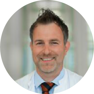 A professional headshot of Mark Stettner, MD, PhD.