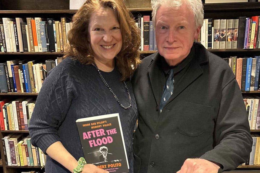 Ann Margaret Daniel stand next to Robert Polito in the Woodstock Public Library, holding a copy of his book AFTER THE FLOOD.