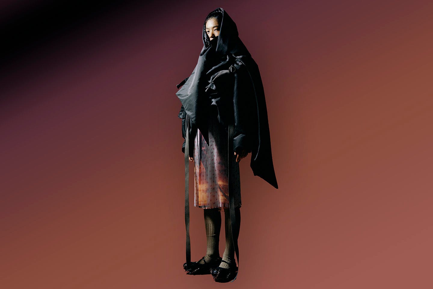 A model wearing a “para-puffer” jacket and Lugged Mary Jane shoes.