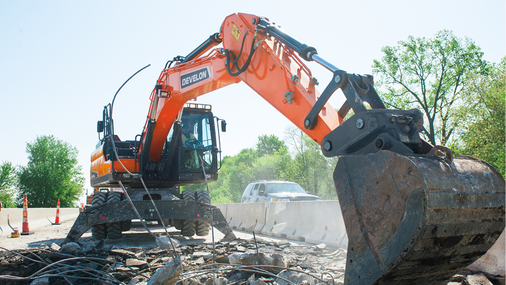 A DEVELON wheel excavator working at a job site.