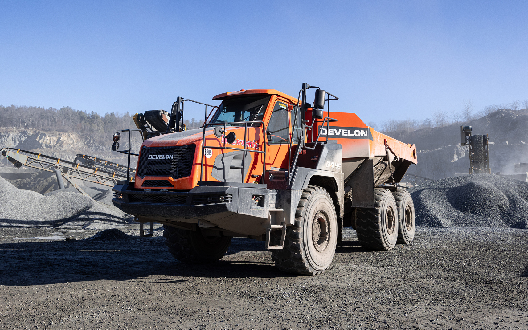A DEVELON DA45-5 articulated dump truck hauls raw material to plants to be processed.