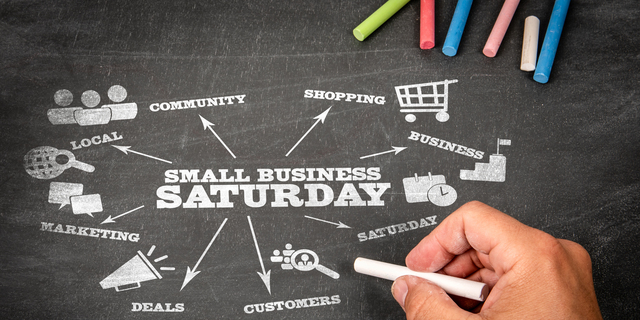 Small Business Saturday. Illustration with icons, arrows and keywords on a black chalkboard background