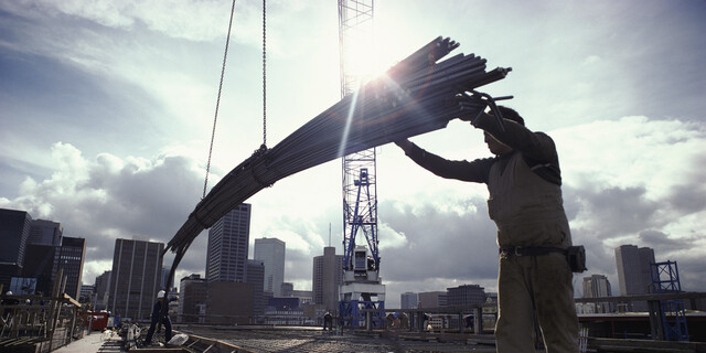 Crane Lowering Girders to Two Builders