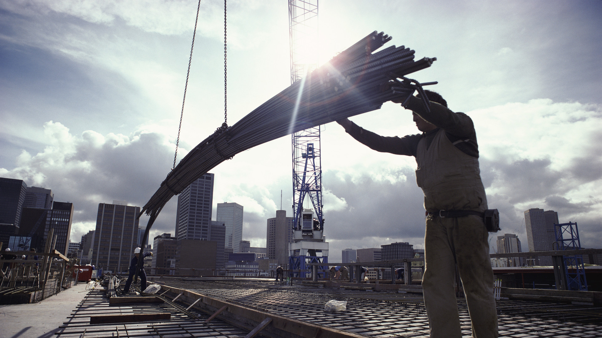 Crane Lowering Girders to Two Builders
