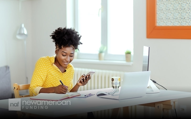 A woman smiling while budgeting