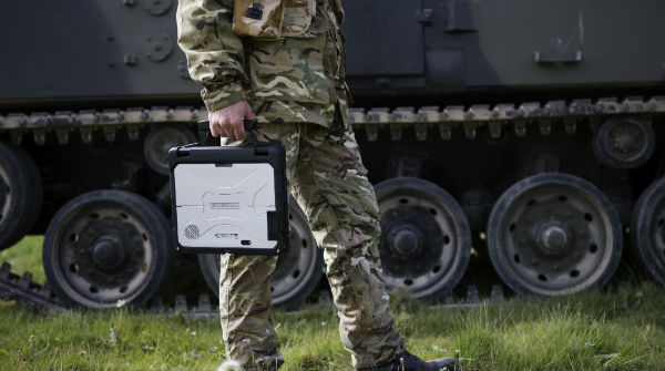 Military personnel carrying mobile military technology.