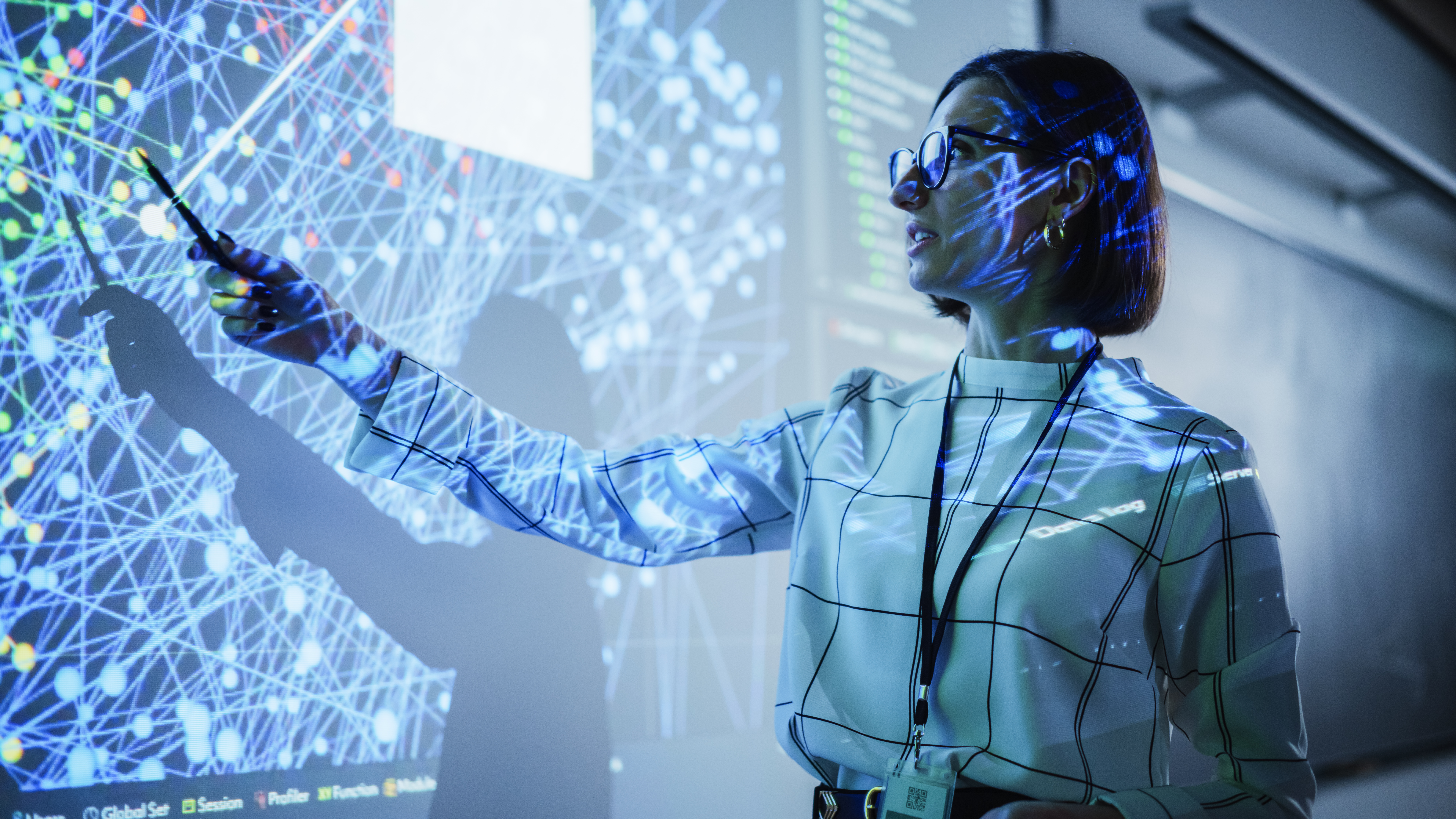 Amidst Panasonic's line of new AV solutions, a woman uses a 4k projector during a presentation with multiple colorful data points.