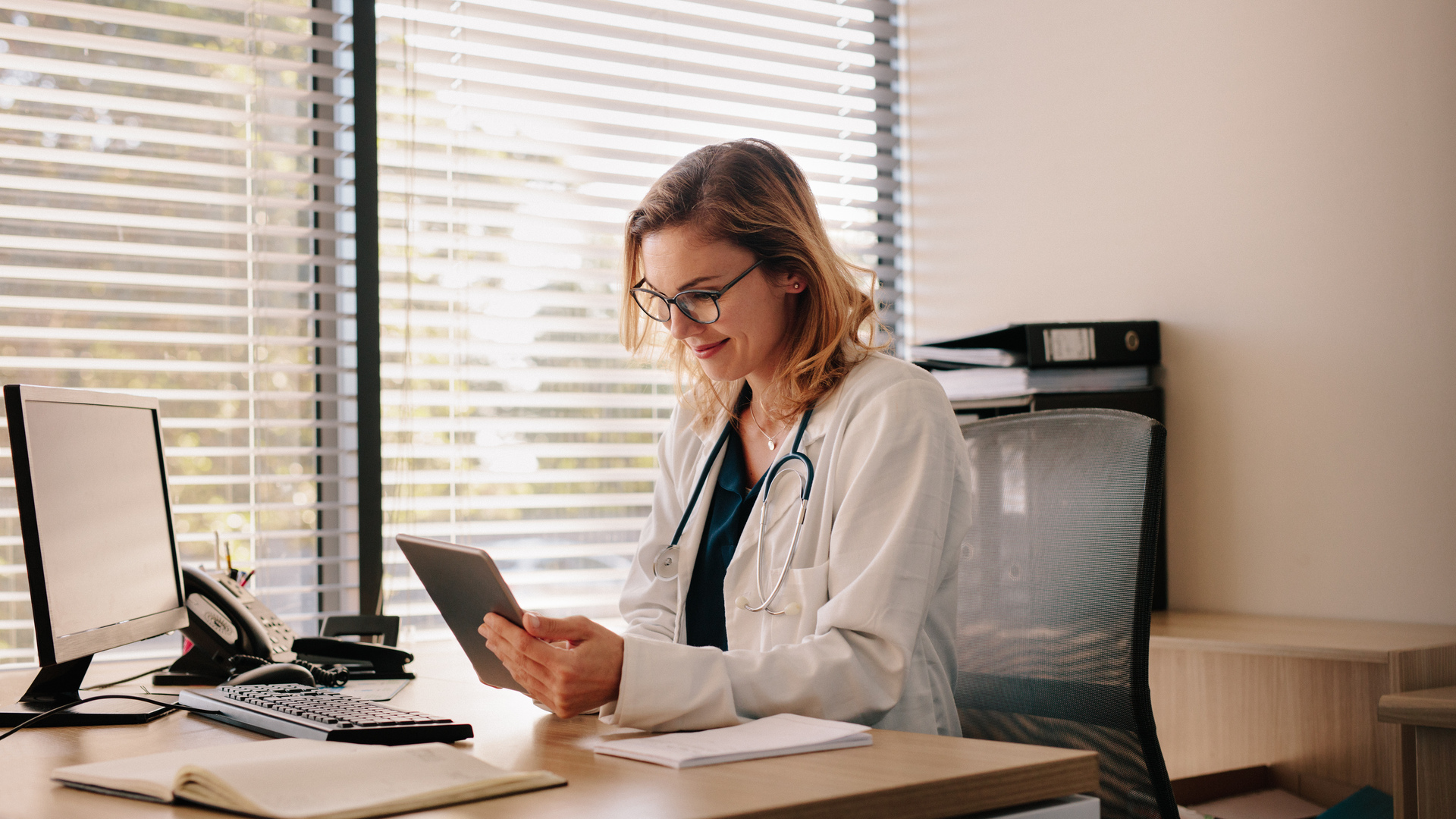 Female doctor working on her tablet pc