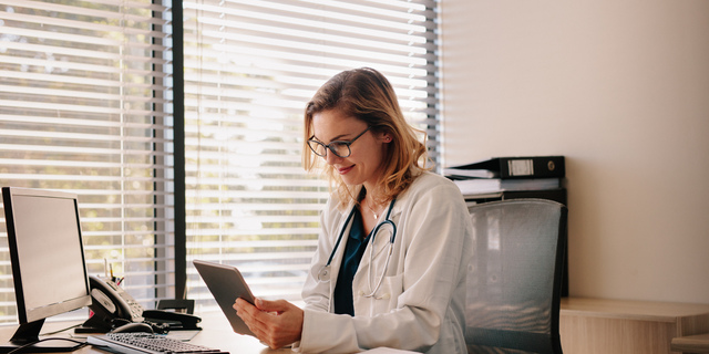 Female doctor working on her tablet pc