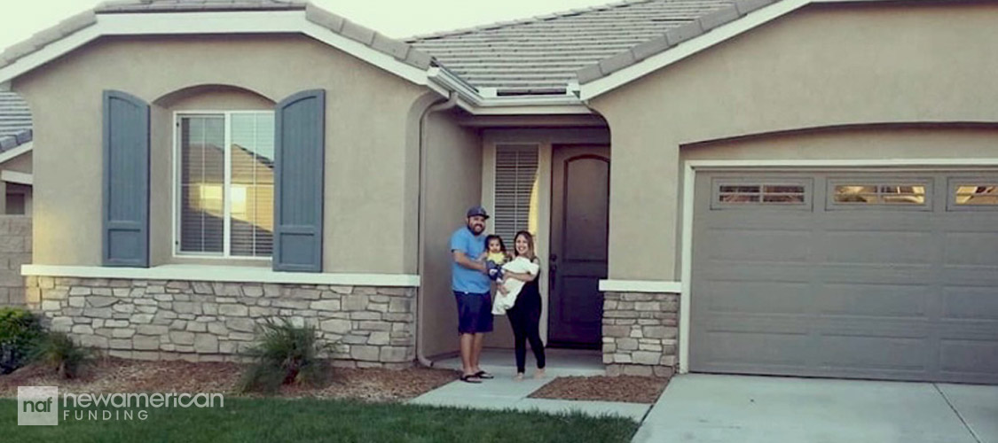 Erika and Pat in front of their new house