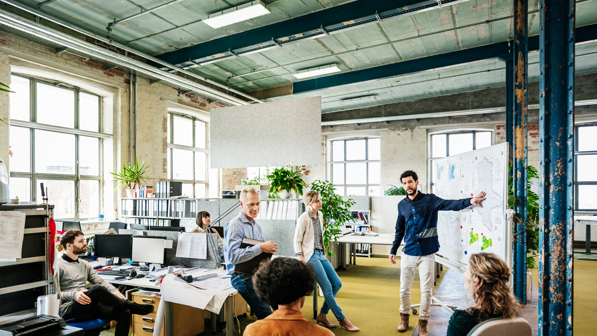 Office Manager Addressing His Team During Morning Meeting