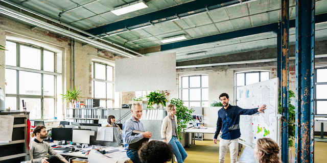 Office Manager Addressing His Team During Morning Meeting