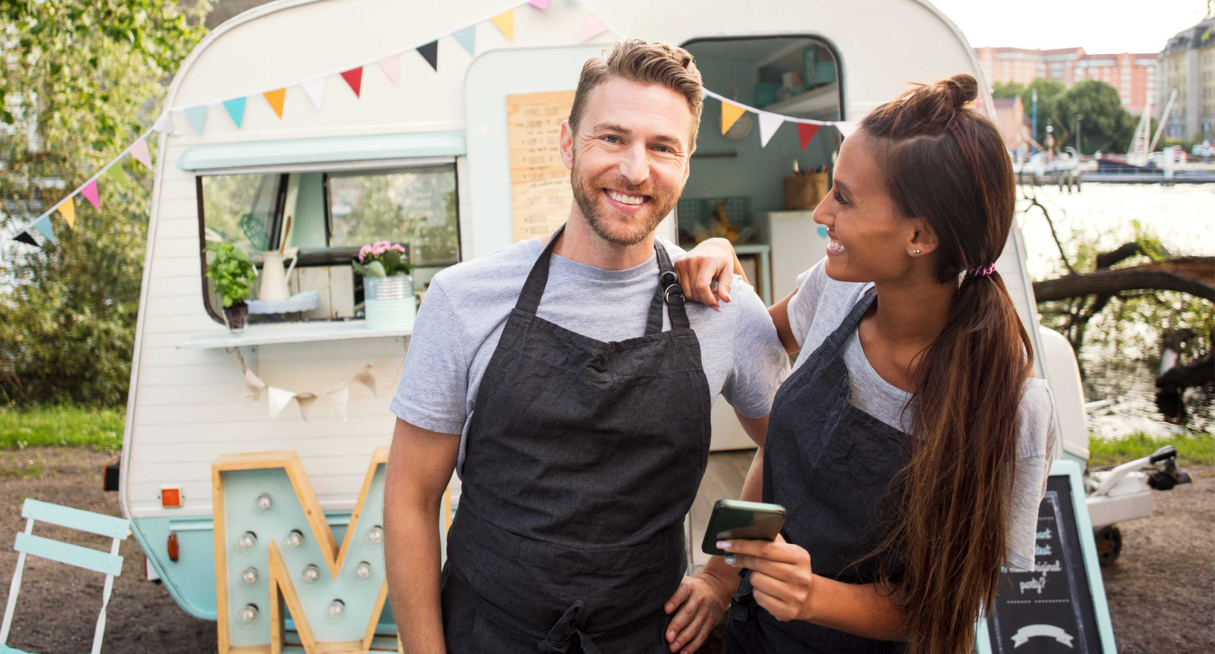 couple smiling in front of shop